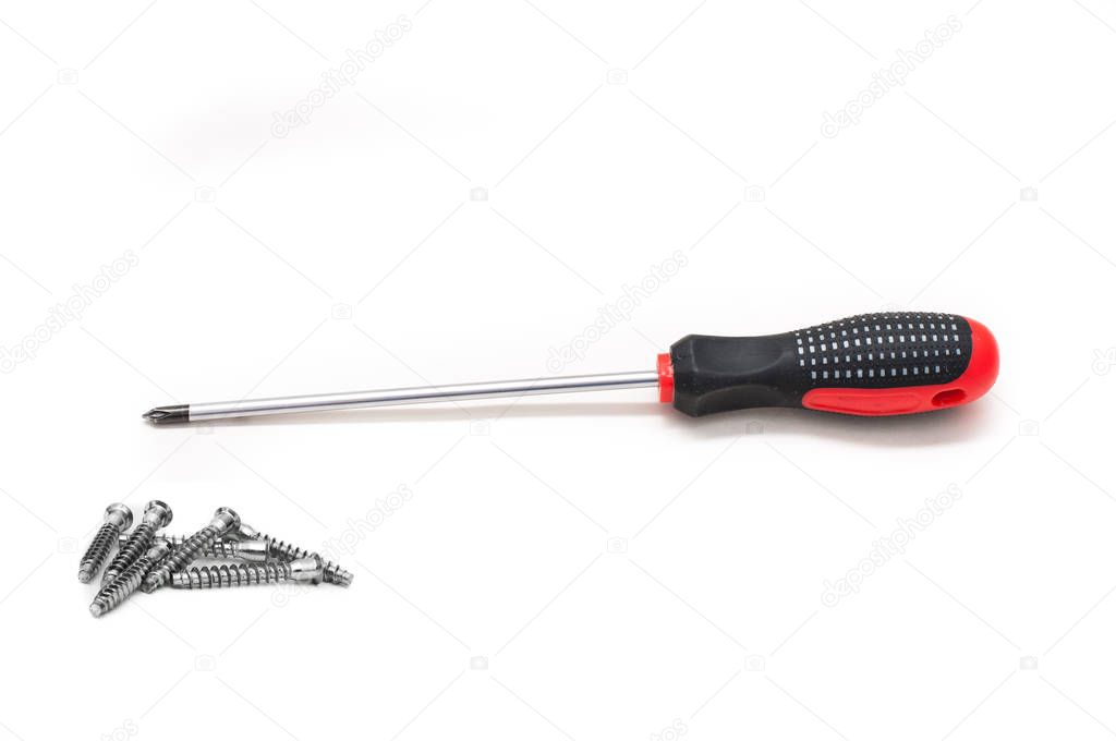 Shiny metal screwdriver for repair with a plastic black and red handle and Screws still life large self tapping, the concept of manual labor and repair. Red screwdriver isolated on white background.