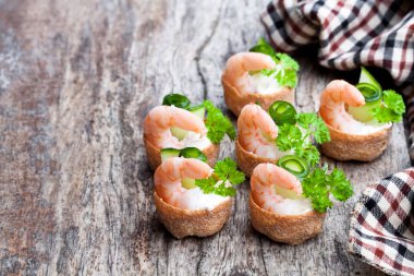 Tuzlu croustades gevrek pasta krem peynir ve ahşap masa üzerinde karides ile doldurulmuş 