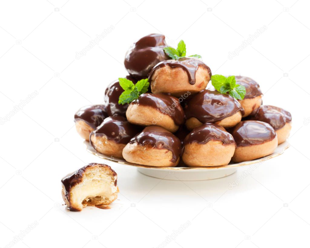Homemade  profiterole choux with chocolate ganache on the plate isolated 