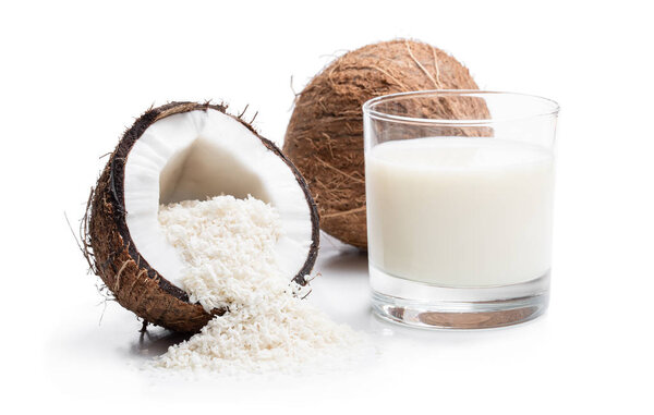 Glass  of fresh coconut milk and flakes isolated on white 