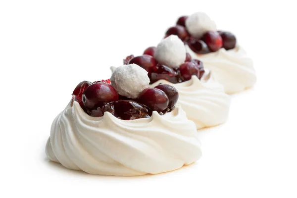 Mini Pavlova meringue nests with fresh and sugared cranberry isolated on white — Stock Photo, Image