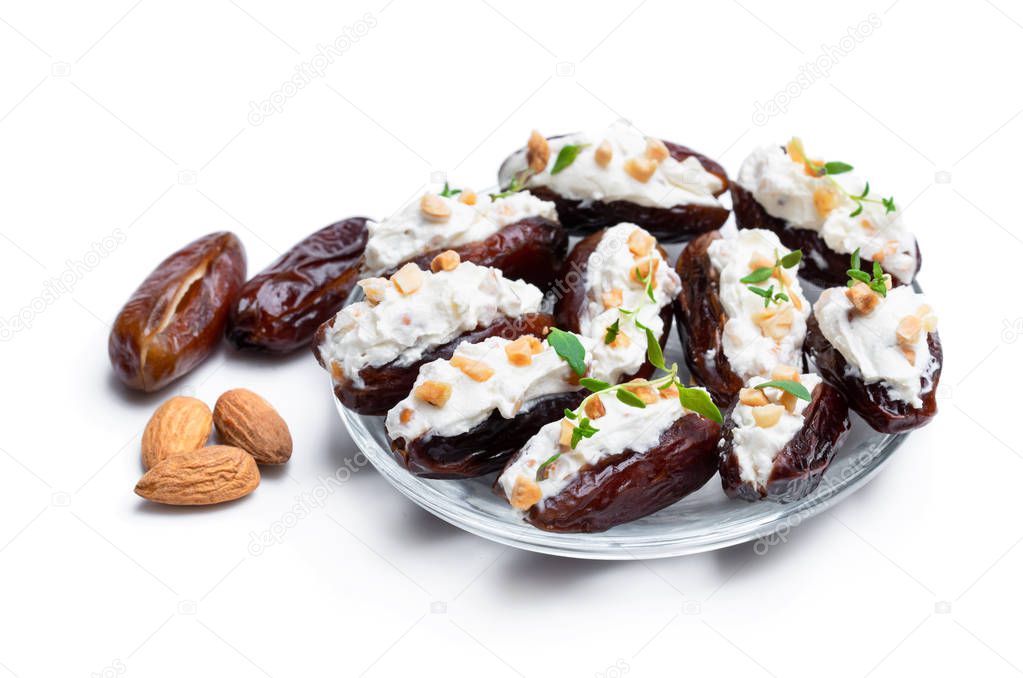 Dates stuffed with cream cheese and almonds isolated on white 