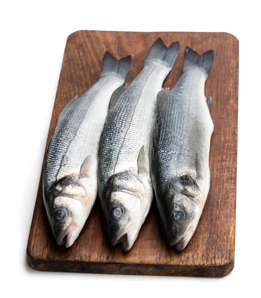 Peixe de robalo inteiro fresco na tábua de corte isolado em um branco — Fotografia de Stock