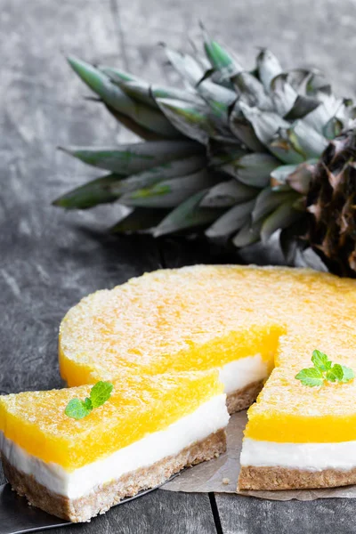Healthy layered pineapple cheese cake on wooden table