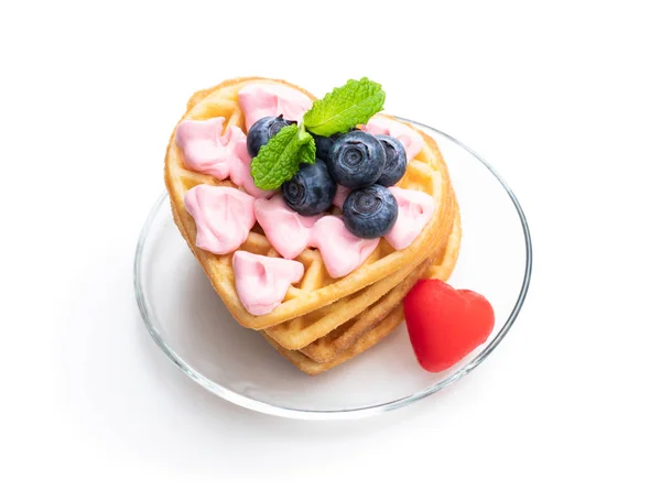 Stack of heart shaped waffles with pink cream and blueberry isolatedon white — Stock Photo, Image