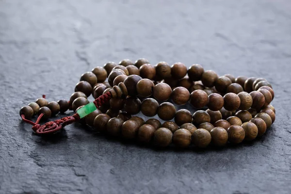 Beads rosary on black stone background