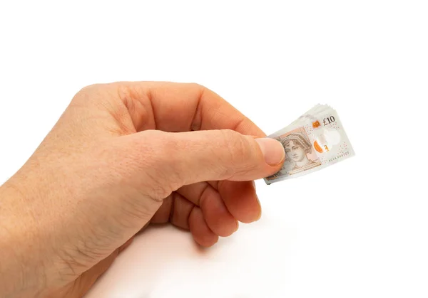 Finance concept hand holding inflated 10 pound bank note — Stock Photo, Image