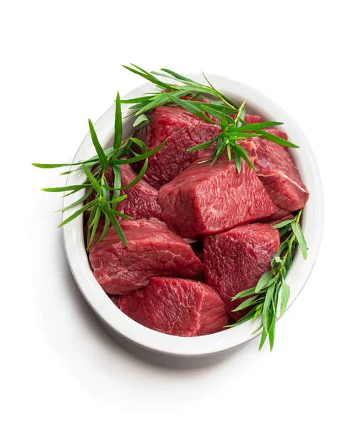 Sliced raw beef with tarragon herb in ceramic bowl isolated on white — Stock Photo, Image