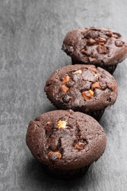 Siyah taş backgroung üzerinde Üçlü çikolatalı kekler 