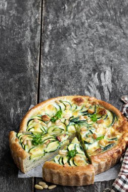 Kabaklı vejetaryen turtası ve ahşap masada çam fıstığı. 