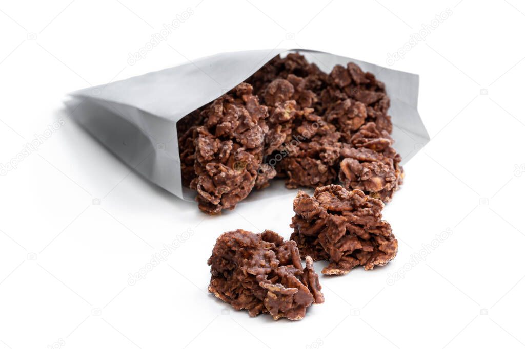 Chocolate  corn flake clusters in paper bag isolated on white 