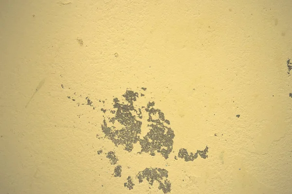Texture of wet, peeling plaster on the wall