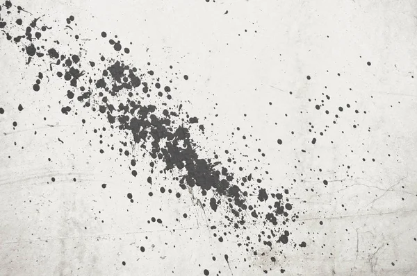 Drops of black paint on a white ceiling