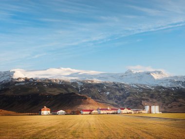 Thorvaldseyri farm and Eyjafjallajkull  in winter clipart