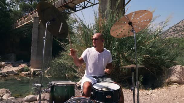 Guy Plays Drums Coolly Nature Expressive Performance Medium Shot Royalty Free Stock Footage