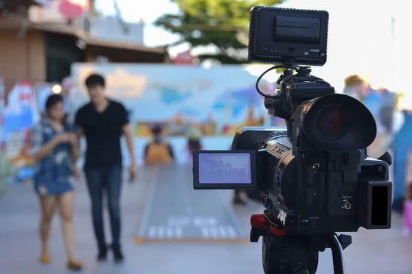 A video camera that uses live video streaming with actors walking in front