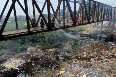 Dakka, Bangladeş, Buriganga nehirde yol açar 30 Kasım kirli bir kanal üzerinden insanlar yürümek, 2018.Bangladesh bildirildi 10 en iyi 20 plastik kirleten dışarı Buriganga Nehri ile dünyada yer almaya devam etmektedir.