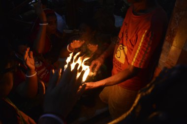 Hindus devotee yüzlerce Dhaka Shamibag Loknath Dham de dini bir Hindu festivali Rakher Upabas kutlamak için hafif mum ile oturur, Bangladeş, Kasım 'Da 14, 2017. Mumların ışığında önünde otur ve namazda absorbe Lokenath Brahmachari.