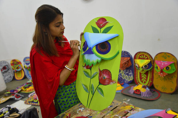 Student of Faculty of Fine arts of Dhaka University painting masks for colorful preparation to celebrate upcoming Bengali New Year 1424 in Dhaka, Bangladesh, April 05, 2017. 