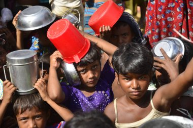 Rohingya mülteci çocukları, 2006 Ekim 'inde Bangladeş, Cox' s Bazar 'daki Palongkhali derme çatma kampında yiyecek toplamak için bekliyor. Birleşmiş Milletler Mülteciler Yüksek Komiserine (UNHCR) göre 525.000 'den fazla Rohingyalı mülteci fro firar etti