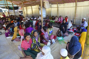 Rohingya Çocukları Kuran 'ı 10 Ekim 2017' de Bangladeş, Cox 's Bazar' daki Balukhali derme çatma kampında bir Madrasa 'da öğreniyorlar. 9 Ekim 'de Myanmar' da binlerce Rohingya 'nın şiddetten kaçması Bangladeş' e akın etti.