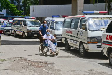 15 Temmuz 2020 'de Bangladeş, Dhaka' daki koronavirüs salgını sırasında tedavi altına alınmak üzere Dhaka Tıp Fakültesi Hastanesi 'ne nakledilen bir hasta
