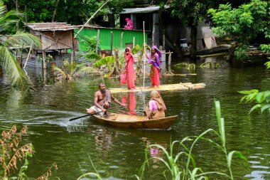 10 Ağustos 2020 'de, Dhaka, Bangladeş yakınlarındaki Savar' da, sel sularından geçen bir tekneye binen köylüler.