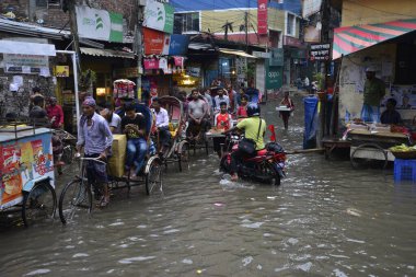 19 Haziran 2015 'te sağanak yağış neredeyse durgunluğa yol açtıktan sonra vatandaşlar, araçlar ve Rickshaw' lar Dhaka 'nın sel basmış sokaklarında yolcularla birlikte araba sürmeye çalıştı. Şiddetli muson yağmurlarının ardından Dhaka 'nın başkentinde bölgenin çoğu sular altında kaldı..