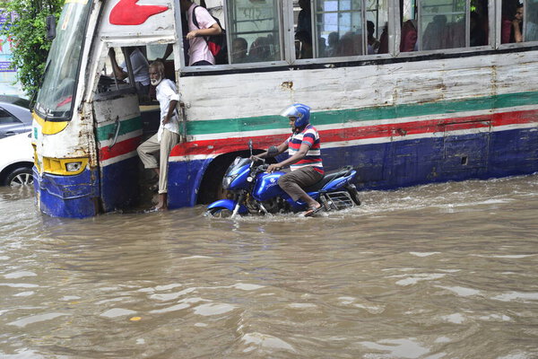 Citizens, Vehicles and Rickshaws try driving with passengers through the flooded streets of Dhaka city after heavy downpour caused almost-standstill, on July 05, 2017. After heavy monsoon rains caused flooded most of area in the capital of Dhaka in B