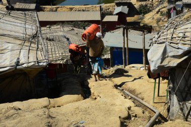 Rohingya mültecileri 2 Şubat 2019 'da Ukhia, Cox' s Bazar, Bangladeş 'teki Balukhali mülteci kampında gaz silindiri taşıyorlar.. 