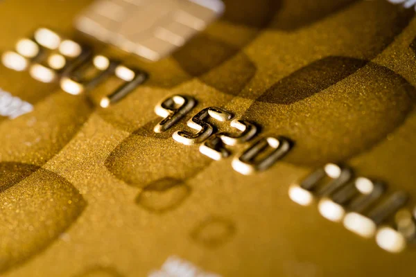 Close up shot of gold credit card on table with selective focus on it