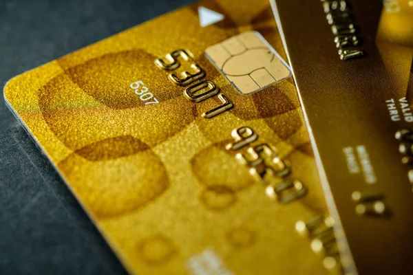 Close up shot of gold credit card on table with selective focus on it