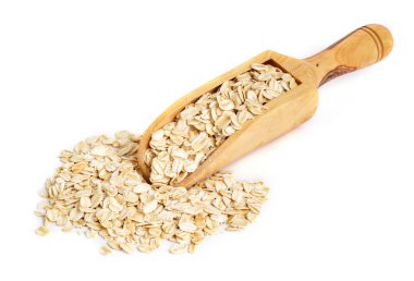 Beyaz arka plan ile ahşap kepçe üzerinde bütün yulaf ezmesi