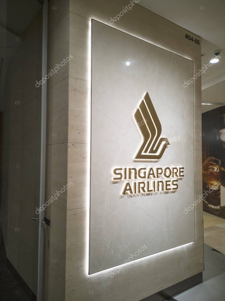 Singapore - 9 Sep, 2025: The iconic SIA Logo, a golden bird in flight, is prominently displayed against a white backdrop at Singapore Airlines Reservation & Ticketing Office in a shopping mall at ION Orchard