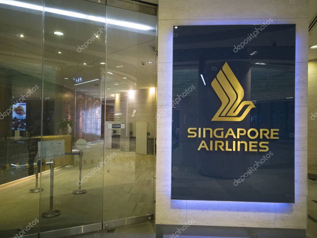 Singapore - 17 March, 2025: The iconic SIA Logo, a golden bird in flight, is prominently displayed against a deep navy-blue backdrop at Singapore Airlines Reservation & Ticketing Office in a shopping mall at ION Orchard