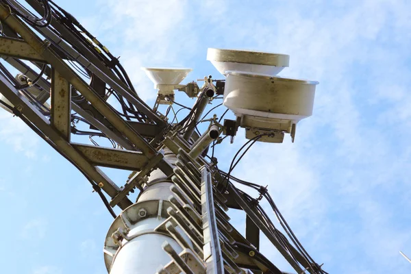 Photo of telecommunication technology with blue sky.