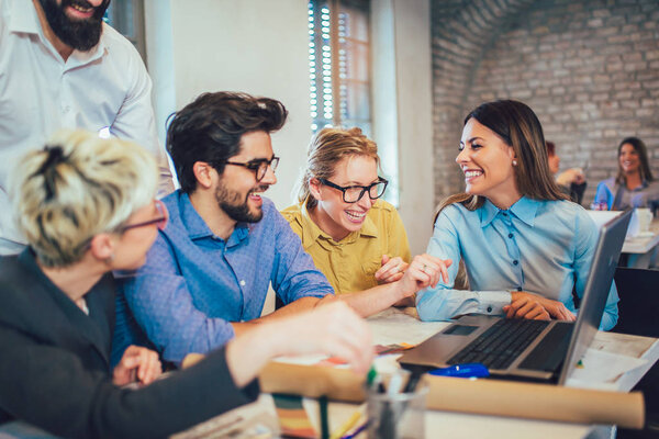 Young creative coworkers discussing new project in office