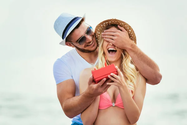 Junger Mann Überrascht Freundin Strand Mit Geschenk — Stockfoto