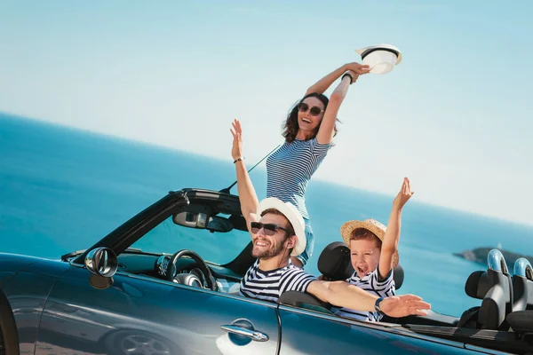 Happy family travel by car to the sea. People having fun in cabriolet. Summer vacation concept