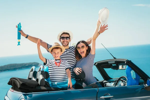 Mutlu aile seyahat ve sahip eğlenceli deniz kenarında cabriolet arabada