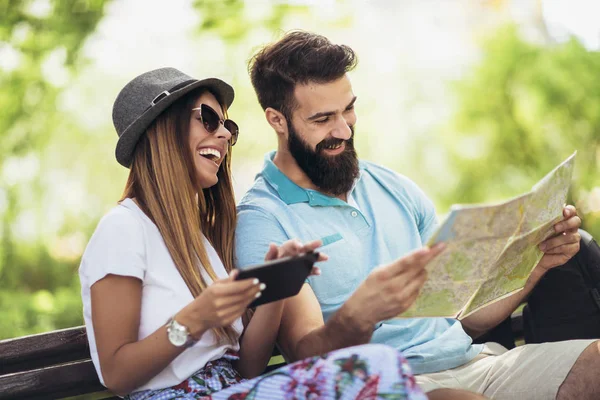 Happy Tourist Couple Looking Map Bench Park Sunny Day — Stock Photo, Image