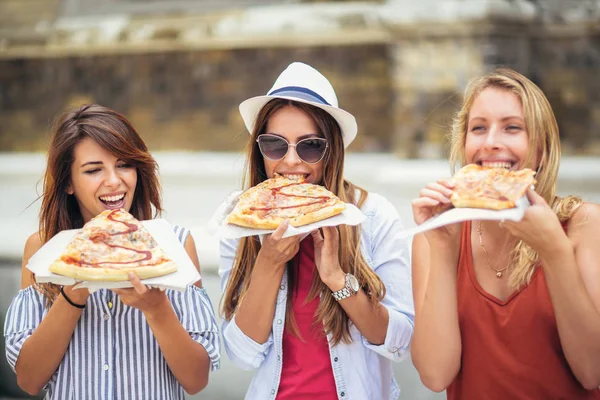 Три Молодые Женщины Едят Пиццу После Покупок Веселятся Вместе — стоковое фото