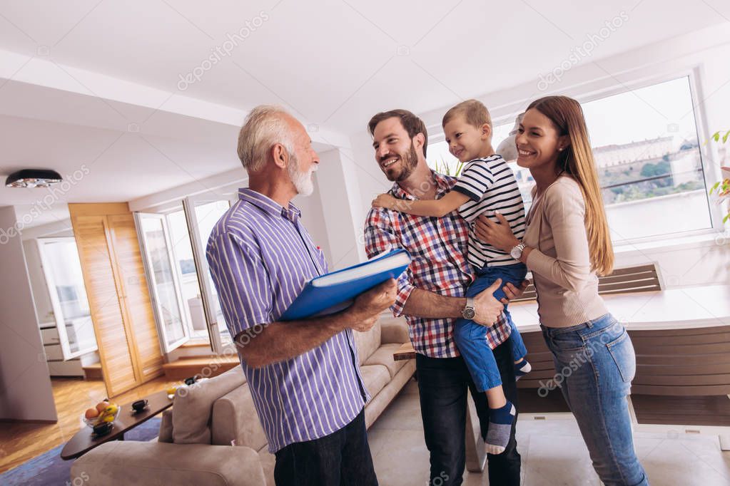 Family with real-estate agent visiting house for sale