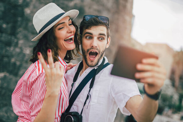 Happy young couple using a digital tablet together and smiling.