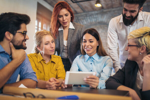  Group of young business people in smart casual wear working together in creative office