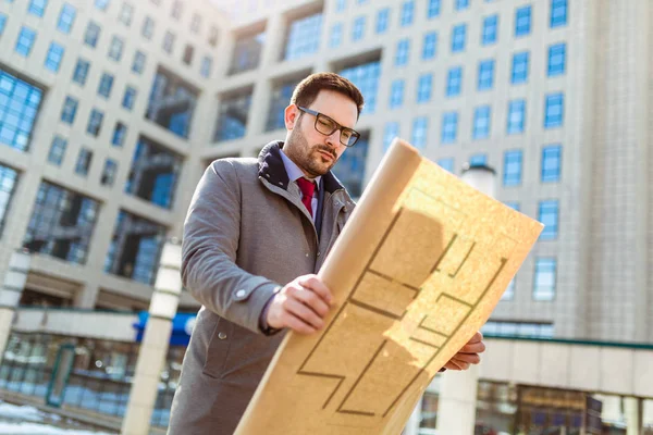 Businessman Holding Blueprint Front Building — Stock Photo, Image