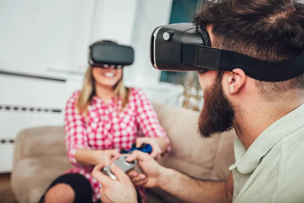 Happy friends playing video games with virtual reality glasses - Young people having fun with new technology console online