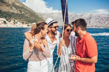 Yelkenli Yat üzerinde arkadaşları gülümseyerek. Tatil, seyahat, deniz, dostluk ve insanlar kavramı