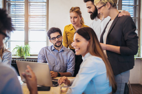 Group of young business people in smart casual wear working together in creative office