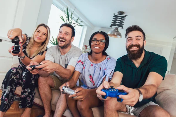 Group of friends play video games together.